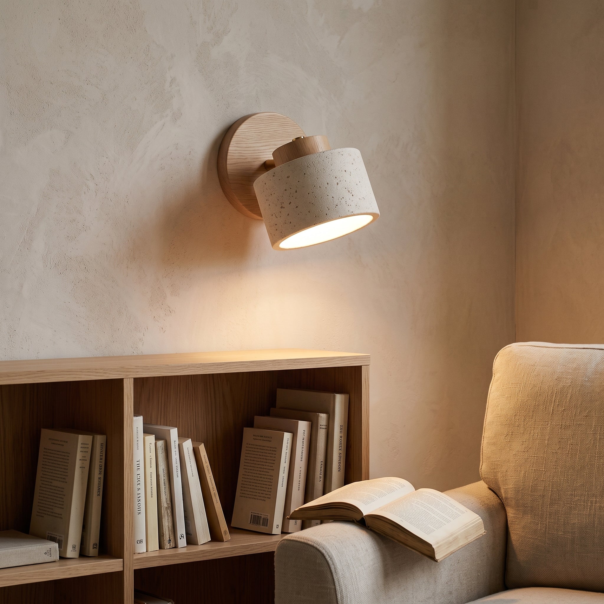 iwa wall light beside a pale oak bookshelf in a living room reading corner