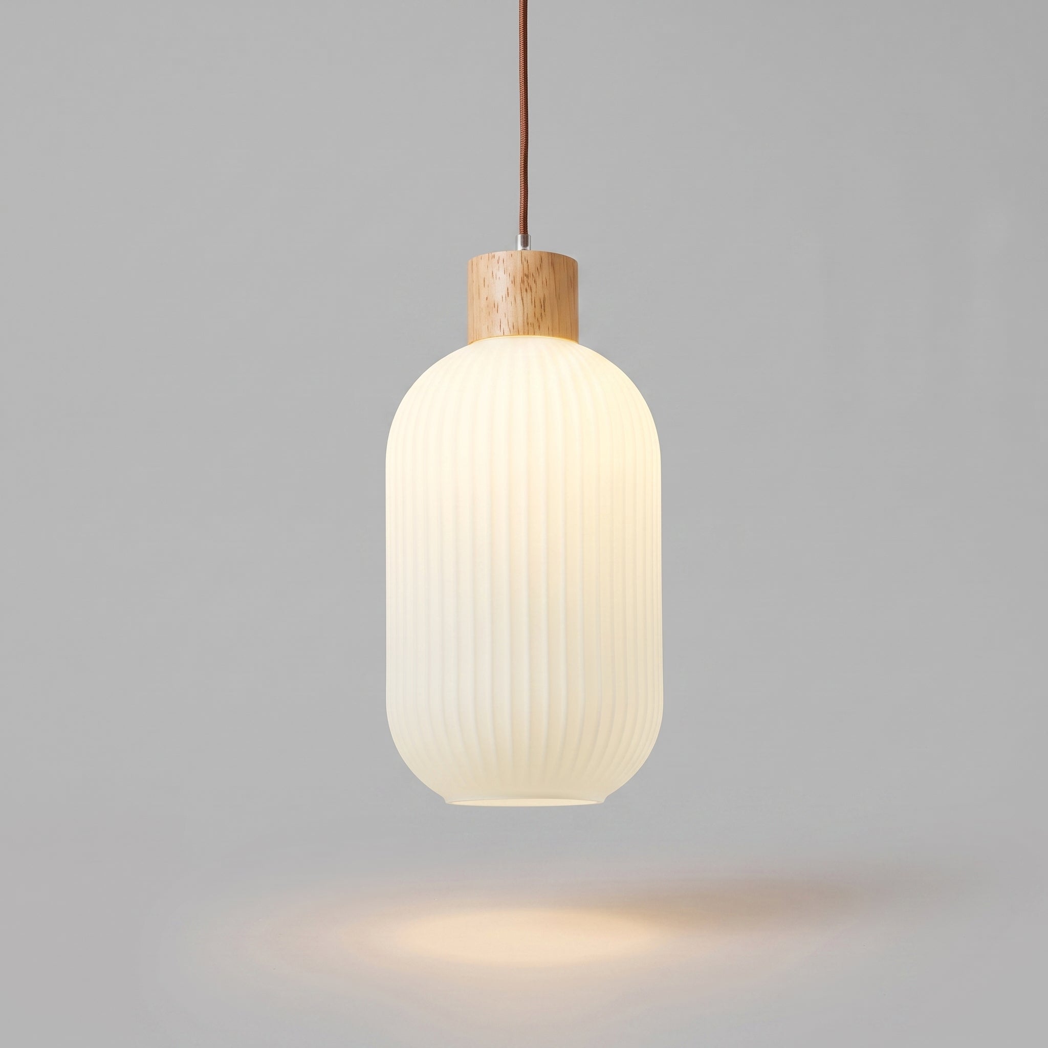 wold pendant light, Cylinder profile, ribbed milk-white glass with pale oak collar, studio hero