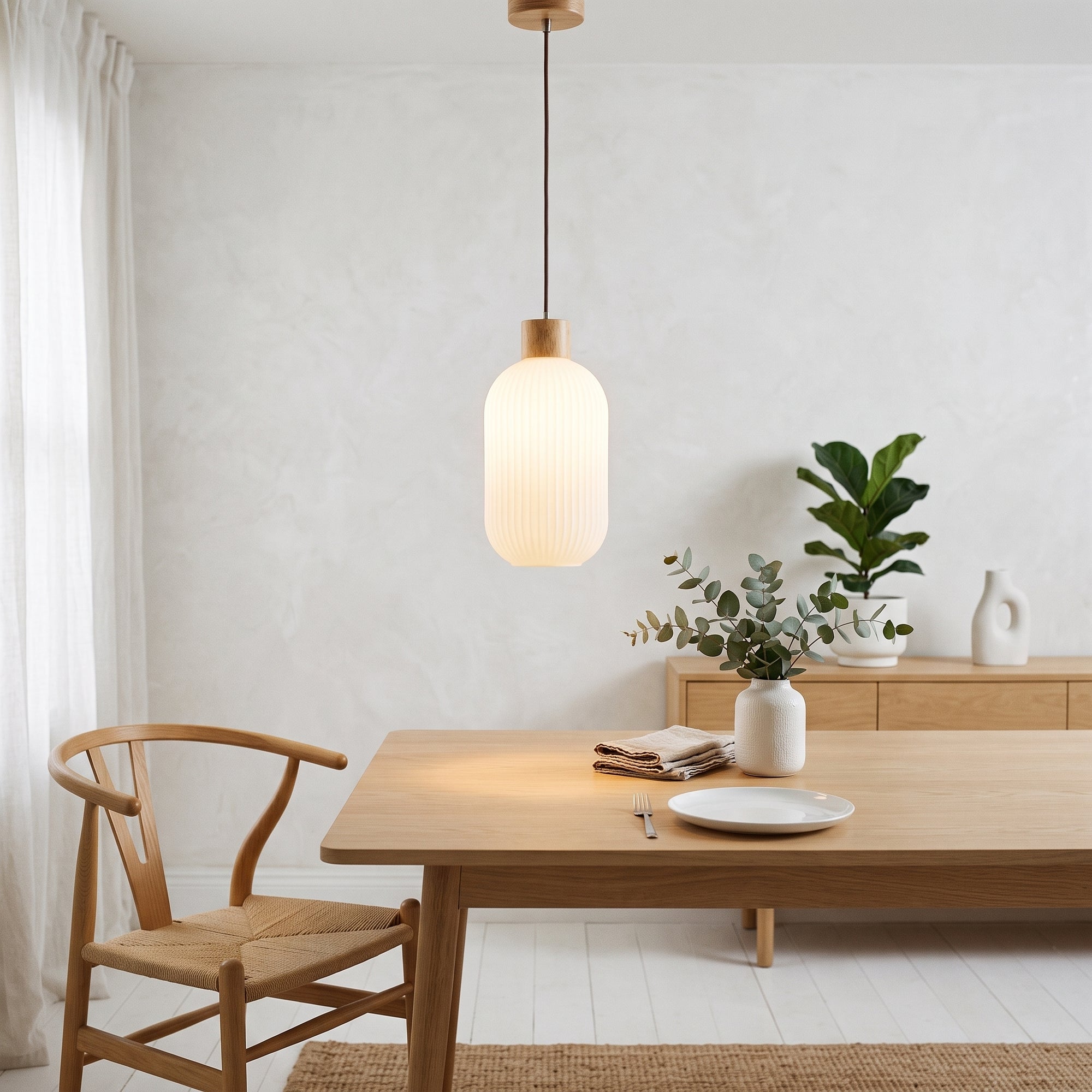 wold pendant light, Cylinder profile, hung over a pale oak dining table